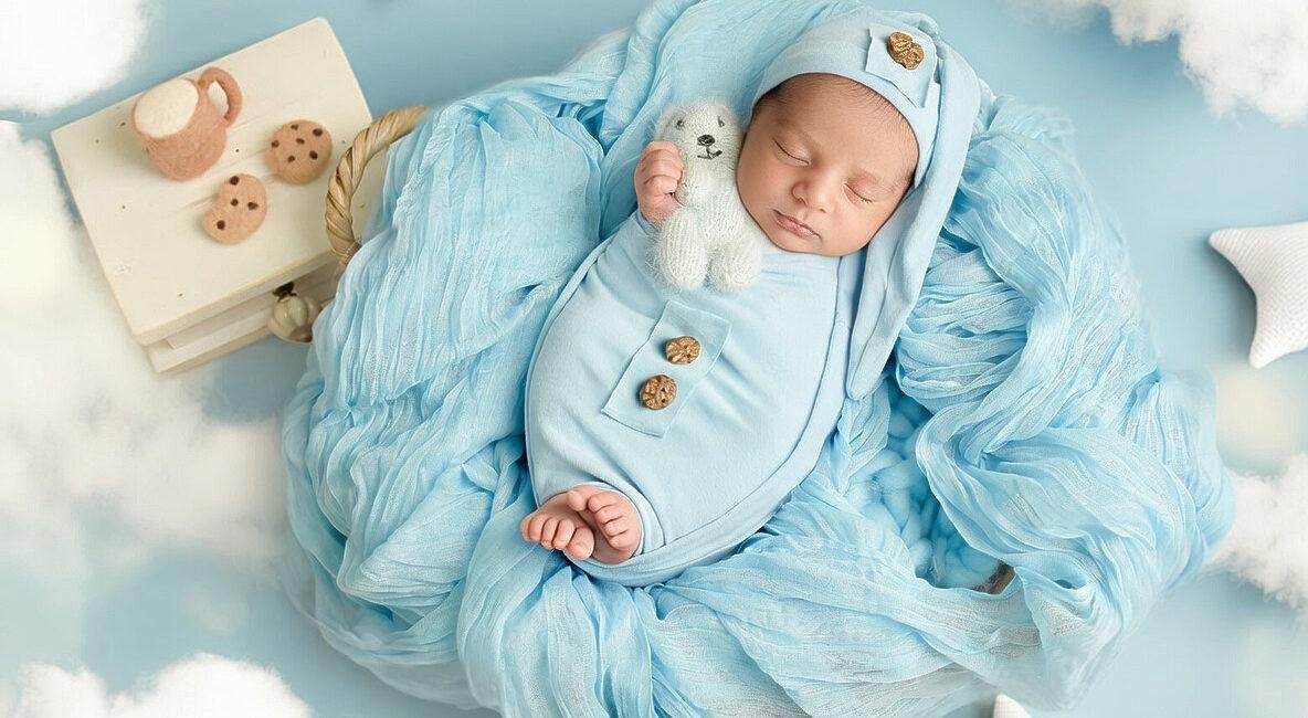Newborn baby in soft blue setup with props and textures – London newborn photographer